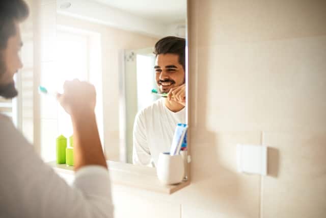 man-brushing-teeth-with-fluoride-toothpaste.jpg
